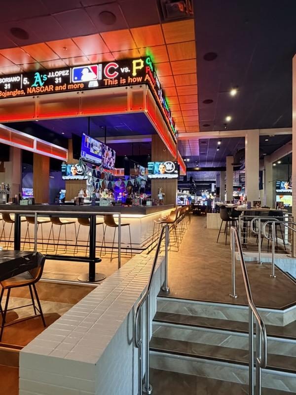 Sports bar interior — LED signage + TVs