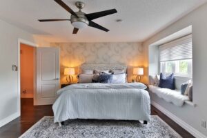 ceiling fan installed in bedroom above bed